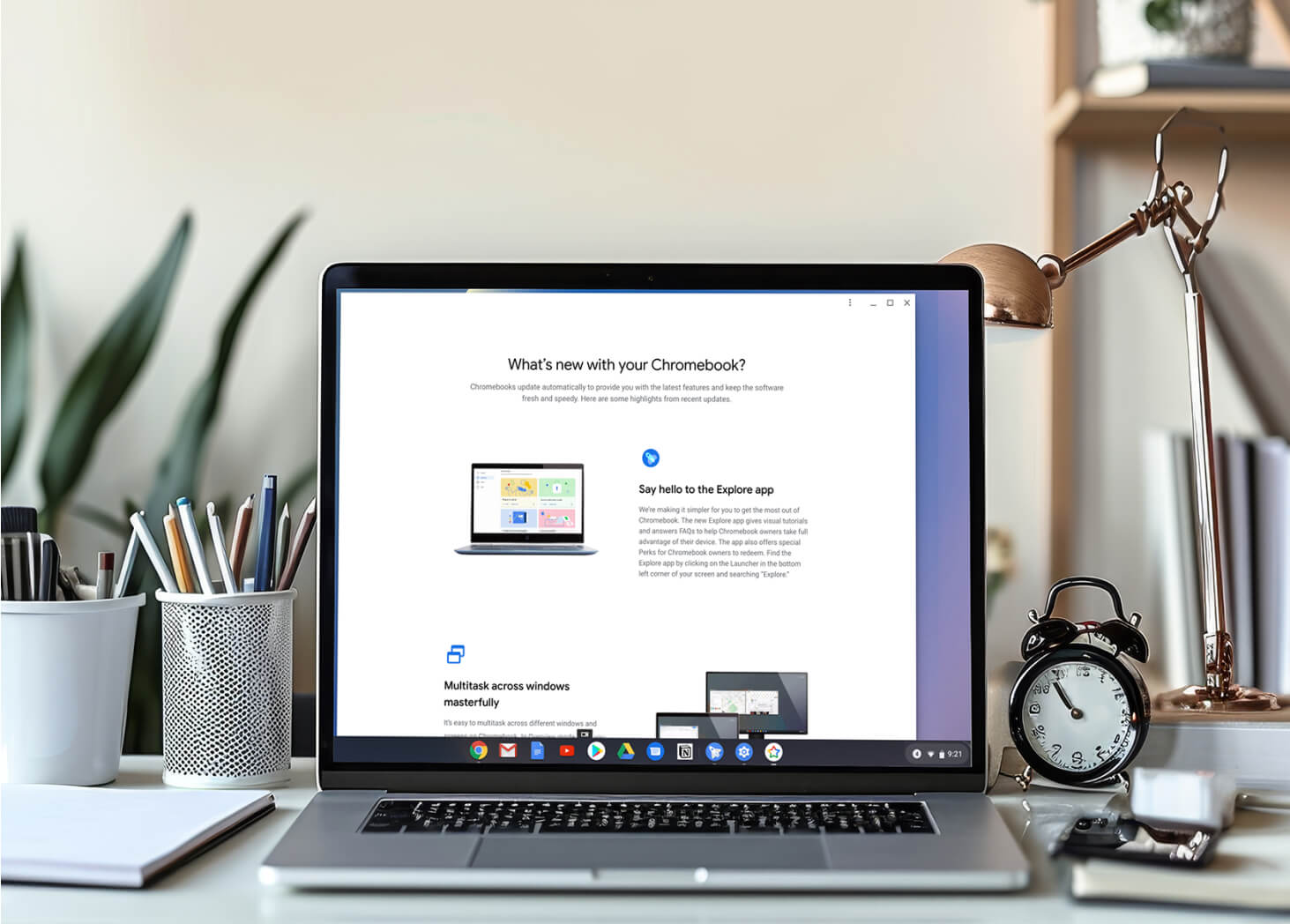 Chromebook displaying new features update on a desk with office supplies